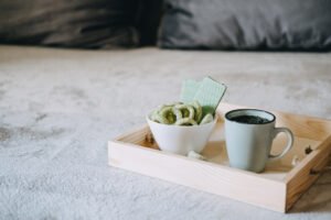 Edibles Causing A Stir in the CBD Industry. CBD Snacks in bowl and cup of herbal tea on wooden tray